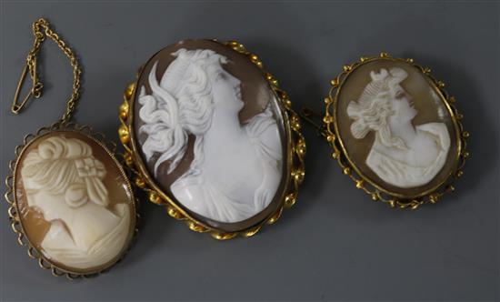 Three assorted mounted cameo brooches including 9ct gold, largest 44mm.